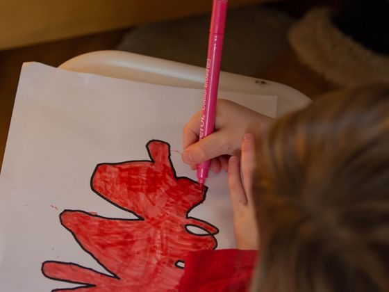 Child practicing fine motor skills at home with an occupational therapist