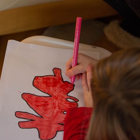 Child practicing fine motor skills such as handwriting at home
